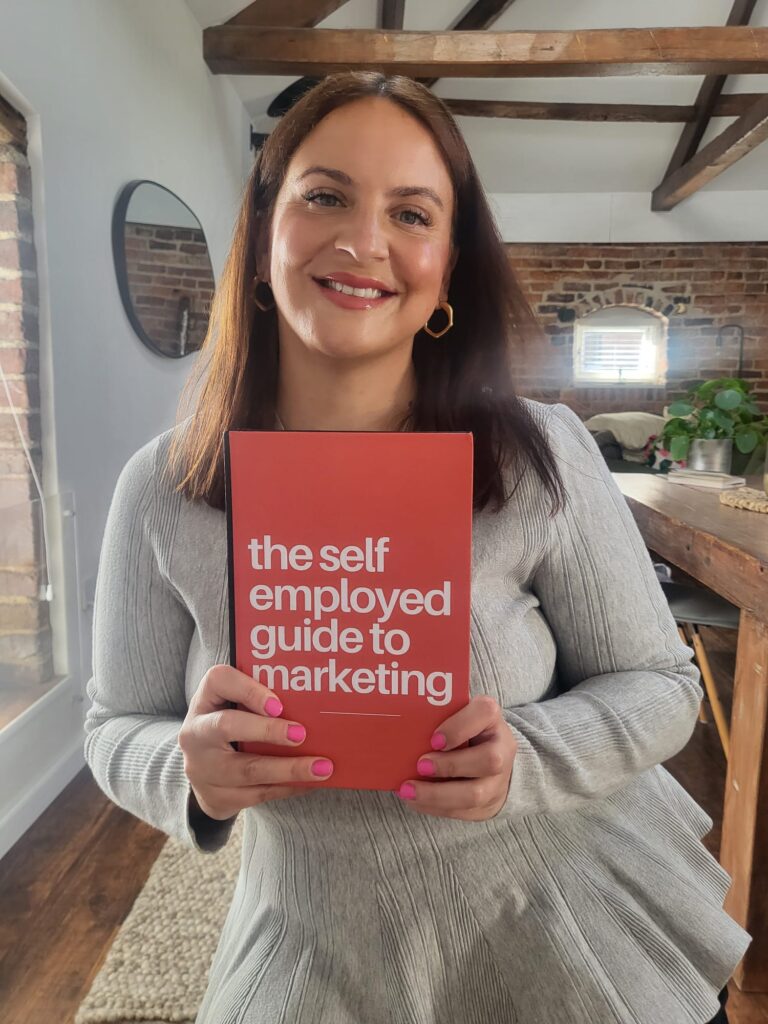 Lucy Thorpe Author of The Self Employed Guide to Marketing holds up a copy of her book.